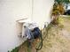 View of an exterior garden hose and reel against a beige home at 11511 Misty Isle Ln, Riverview, FL 33579