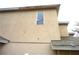 Beige home featuring stucco siding with multiple windows at 11511 Misty Isle Ln, Riverview, FL 33579