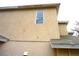 Beige home featuring stucco siding with multiple windows at 11511 Misty Isle Ln, Riverview, FL 33579