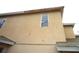 Beige home featuring stucco siding with multiple windows at 11511 Misty Isle Ln, Riverview, FL 33579
