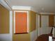 Hallway with decorative molding, paneled walls, and door frames at 11511 Misty Isle Ln, Riverview, FL 33579