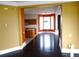 Open-concept layout with hardwood floors flowing from living area to the kitchen and dining space at 11511 Misty Isle Ln, Riverview, FL 33579
