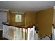 A landing with railing and dark yellow walls at 11511 Misty Isle Ln, Riverview, FL 33579