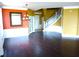 Open living area with hardwood floors, wainscoting, a staircase, and stylish lighting fixture at 11511 Misty Isle Ln, Riverview, FL 33579