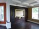 Spacious living room with hardwood floors, coffered ceiling, and a media center at 11511 Misty Isle Ln, Riverview, FL 33579