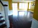 Bright living room with dark hardwood floors, large windows, and a stylish chandelier at 11511 Misty Isle Ln, Riverview, FL 33579