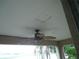 Covered porch with a ceiling fan, and visible sky and trees in the distance at 11511 Misty Isle Ln, Riverview, FL 33579