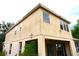 Rear exterior view of the two-story home showcasing the covered patio and ample windows at 11511 Misty Isle Ln, Riverview, FL 33579