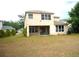 Two-story home with a back patio, large windows, and a spacious backyard at 11511 Misty Isle Ln, Riverview, FL 33579