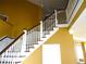 Staircase with white railings and brown accents, ascending to the upper level of the home at 11511 Misty Isle Ln, Riverview, FL 33579