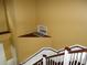 Looking down on a staircase with yellow walls at 11511 Misty Isle Ln, Riverview, FL 33579