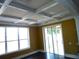 Sunroom with a coffered ceiling, large windows, and sliding glass doors leading to the backyard at 11511 Misty Isle Ln, Riverview, FL 33579