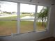 Window view featuring pond, grass, and nearby homes at 11511 Misty Isle Ln, Riverview, FL 33579