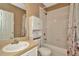 Bathroom features a vanity, toilet, and shower/tub combo with white tile at 10429 Heron Lake Dr, Riverview, FL 33578