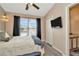 Cozy bedroom features a ceiling fan, closet, and mounted TV at 10429 Heron Lake Dr, Riverview, FL 33578