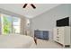 Comfortable bedroom with a dresser, chair, TV, and natural light at 10429 Heron Lake Dr, Riverview, FL 33578