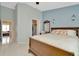 Spacious bedroom with a large bed, mirror, closet, and view to adjacent rooms at 10429 Heron Lake Dr, Riverview, FL 33578