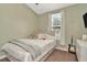 Cozy bedroom with a twin bed, window, and stylish accents at 10429 Heron Lake Dr, Riverview, FL 33578