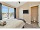 Comfortable bedroom with a closet, TV, and a glimpse into the ensuite bathroom at 10429 Heron Lake Dr, Riverview, FL 33578
