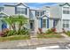 Beautiful townhomes featuring blue shutters and colorful landscaping at 10429 Heron Lake Dr, Riverview, FL 33578