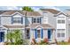 Well-maintained townhomes featuring blue shutters and lush landscaping at 10429 Heron Lake Dr, Riverview, FL 33578