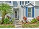 Inviting front entrance with a well-manicured garden and charming accents at 10429 Heron Lake Dr, Riverview, FL 33578
