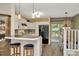 Modern kitchen featuring white cabinets, breakfast bar and backyard view at 10429 Heron Lake Dr, Riverview, FL 33578