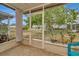 This is a view of the screened porch, with tile flooring and backyard views at 10429 Heron Lake Dr, Riverview, FL 33578