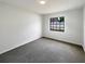 Clean bedroom featuring plush carpet, natural light and a neutral color scheme at 11114 Shadybrook Dr, Tampa, FL 33625