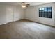 Bedroom with neutral carpet, a window for natural light, and a door to the rest of the home at 11114 Shadybrook Dr, Tampa, FL 33625