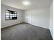 Bright bedroom featuring plush carpet, a window for natural light, and a closet at 11114 Shadybrook Dr, Tampa, FL 33625