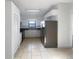 Updated kitchen with stainless steel appliances and white cabinetry, complemented by tile flooring at 11114 Shadybrook Dr, Tampa, FL 33625