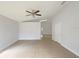 Bright living room featuring tile flooring, a ceiling fan, and access to other parts of the home at 11114 Shadybrook Dr, Tampa, FL 33625
