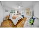 Bright bedroom with light hardwood floors, a ceiling fan, and cheerful decor at 307 N Glen Ave, Tampa, FL 33609