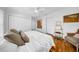 Bedroom with hardwood floors, white walls, ceiling fan, and decorative artwork at 307 N Glen Ave, Tampa, FL 33609