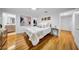 Bedroom with hardwood floors, a view to the ensuite bathroom, and natural light at 307 N Glen Ave, Tampa, FL 33609