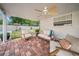 Cozy covered patio featuring comfortable seating and a ceiling fan at 307 N Glen Ave, Tampa, FL 33609