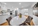 Dining area adjacent to a kitchen with modern lighting, a white table, and four chairs at 307 N Glen Ave, Tampa, FL 33609