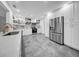 Spacious white kitchen featuring stainless steel appliances, custom cabinets, and stone countertops at 307 N Glen Ave, Tampa, FL 33609