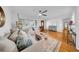 Spacious living room featuring hardwood floors, a ceiling fan, and plenty of natural light at 307 N Glen Ave, Tampa, FL 33609