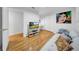 Comfortable living room with hardwood floors, a contemporary TV stand and abstract art at 307 N Glen Ave, Tampa, FL 33609