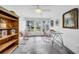 Bright sun room with tiled floor, vintage bookshelf and backyard views at 307 N Glen Ave, Tampa, FL 33609