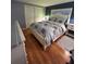 Bedroom features a white bed frame with under-bed storage and wooden floors, creating a spacious vibe at 5258 Wisteria Cir, New Port Richey, FL 34653