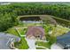 Aerial view showcasing the home, landscaping, pond, pool, and cul-de-sac street at 27740 Water Ash Dr, Wesley Chapel, FL 33544