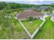 Aerial view of a well-maintained backyard with perimeter fencing and scenic pond views at 27740 Water Ash Dr, Wesley Chapel, FL 33544