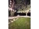 Lush backyard featuring shaded picnic area with a concrete patio and lighting at 27740 Water Ash Dr, Wesley Chapel, FL 33544