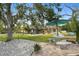 Serene backyard with a hammock, patio furniture, and lush landscaping, creating a tranquil outdoor retreat at 27740 Water Ash Dr, Wesley Chapel, FL 33544