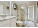 Modern bathroom features glass walk in shower, white cabinet and brushed nickel finishes at 27740 Water Ash Dr, Wesley Chapel, FL 33544