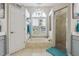 Bright bathroom features a soaking tub under a window and a glass-enclosed shower at 27740 Water Ash Dr, Wesley Chapel, FL 33544
