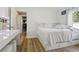 Bedroom with hardwood floors, large mirror for makeup, and large bed frame with drawers at 27740 Water Ash Dr, Wesley Chapel, FL 33544